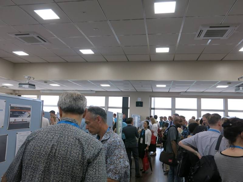 Attendees browsing poster presentations at a past conference